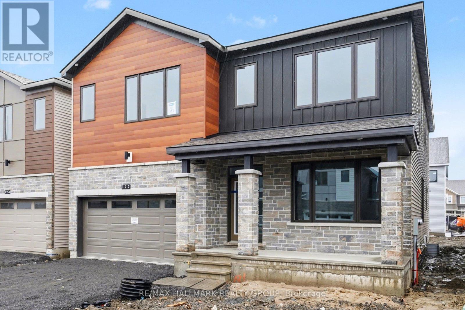 A modern house with a garage is under construction.