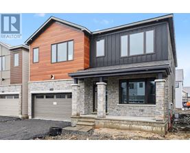 A modern house with a garage is under construction.