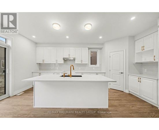 A white kitchen with a sink and cabinets.
