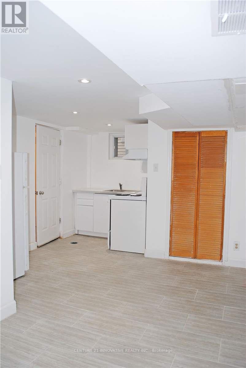 A kitchen with white cabinets and a white dishwasher.