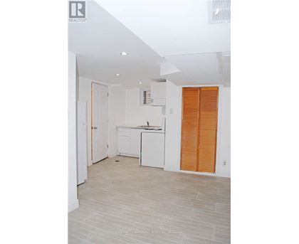 A kitchen with white cabinets and a white dishwasher.