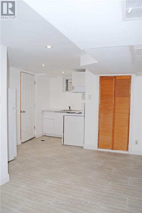 A kitchen with white cabinets and a white dishwasher.