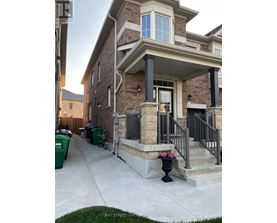 A house with a front porch and a garage door.