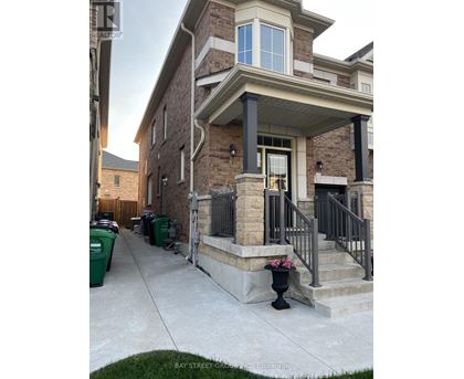 A house with a front porch and a garage door.