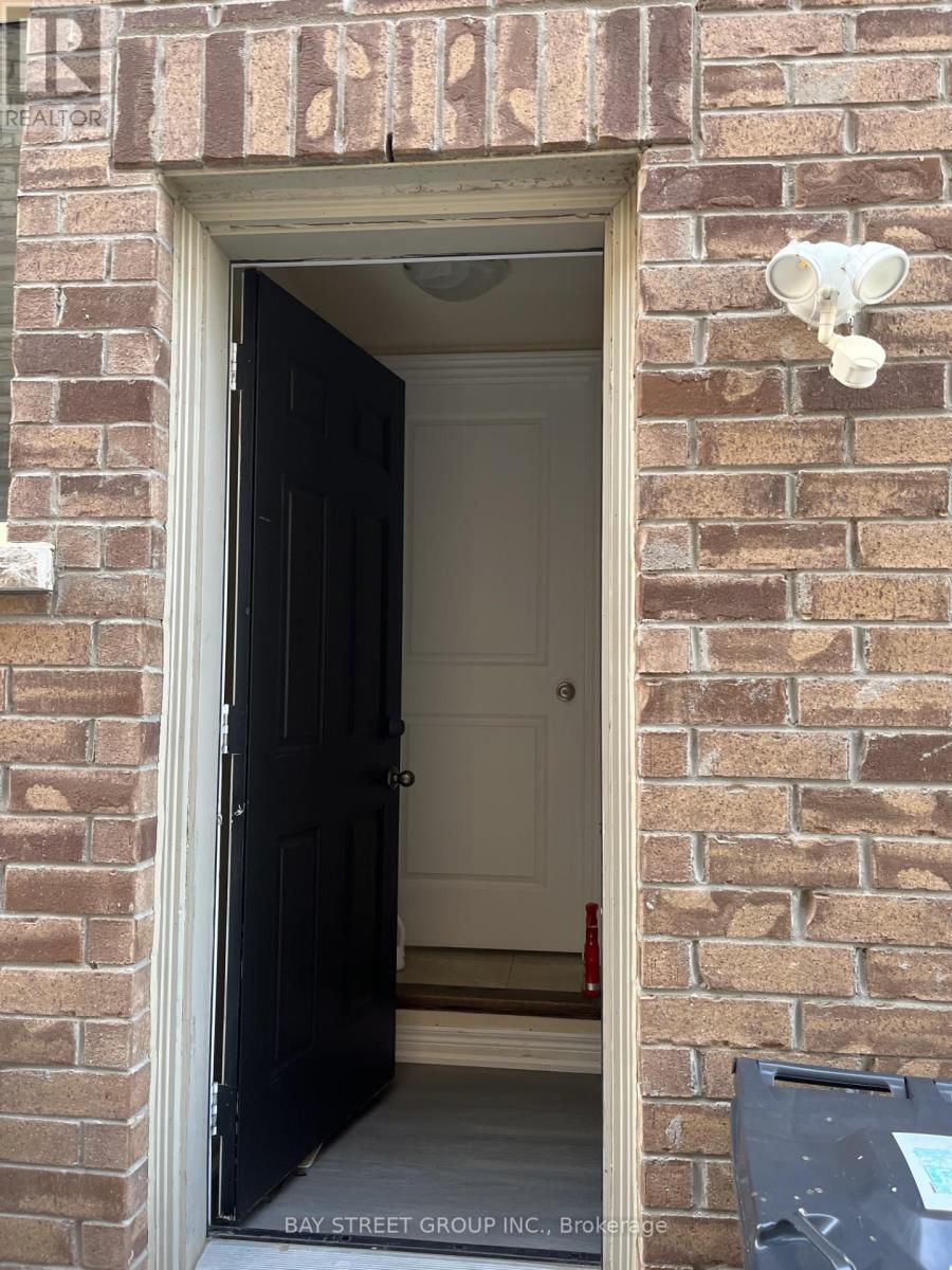 A doorway with a black door and a sign above it that says "REALTOR".