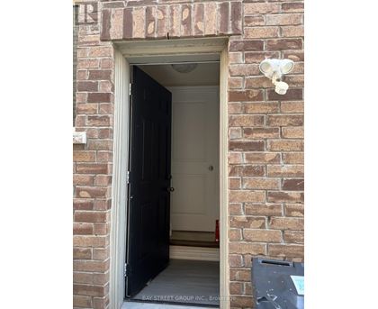 A doorway with a black door and a sign above it that says "REALTOR".