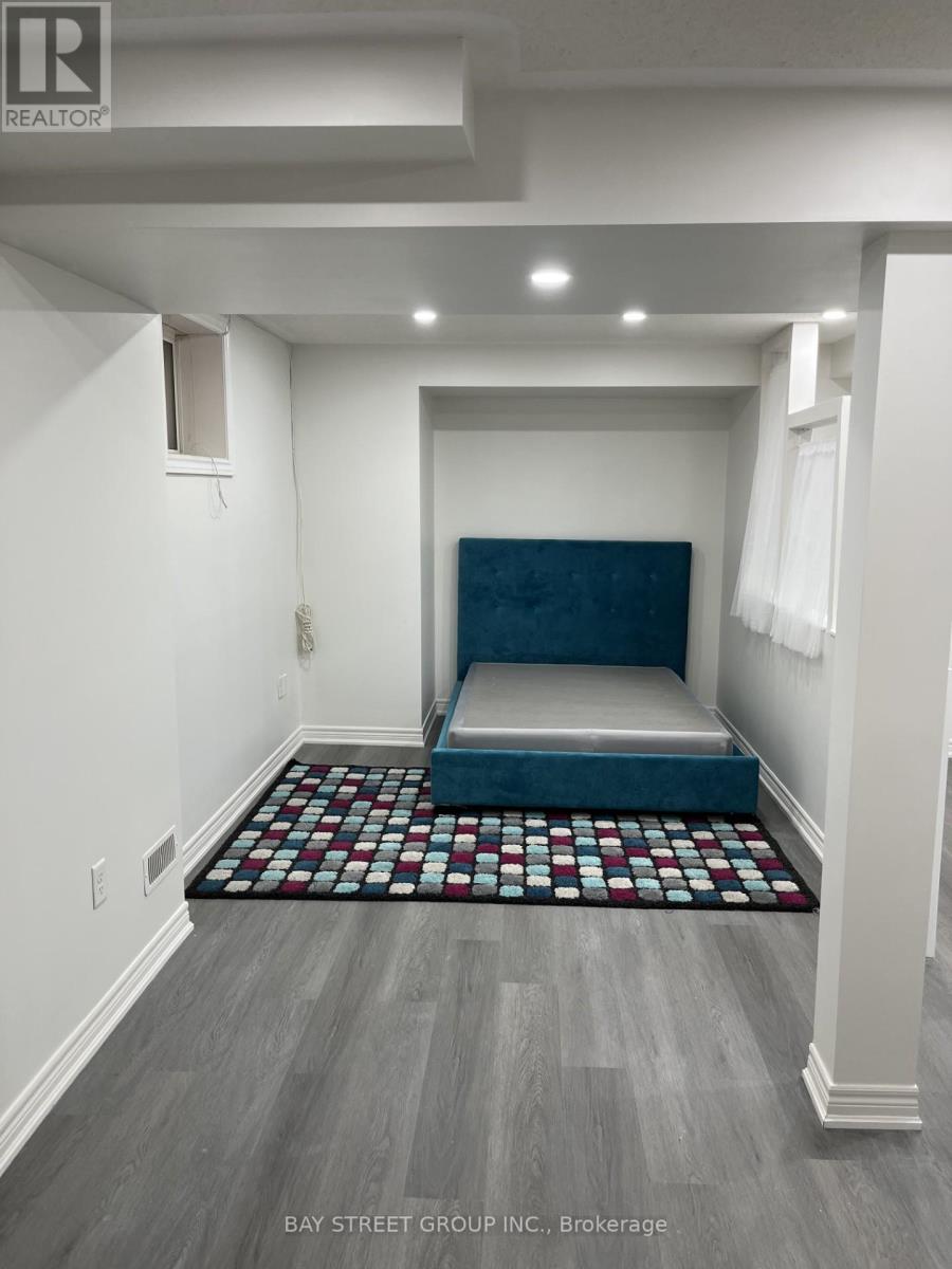 A bedroom with a bed in the middle of the room.