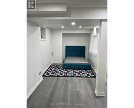 A bedroom with a bed in the middle of the room.