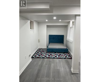 A bedroom with a bed in the middle of the room.