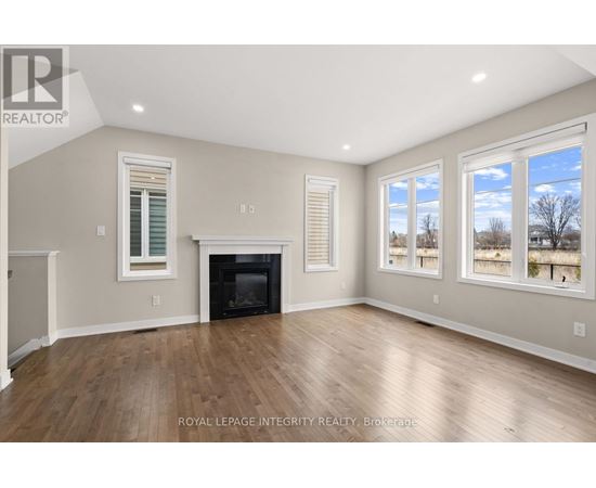 A spacious room with a fireplace and large windows.
