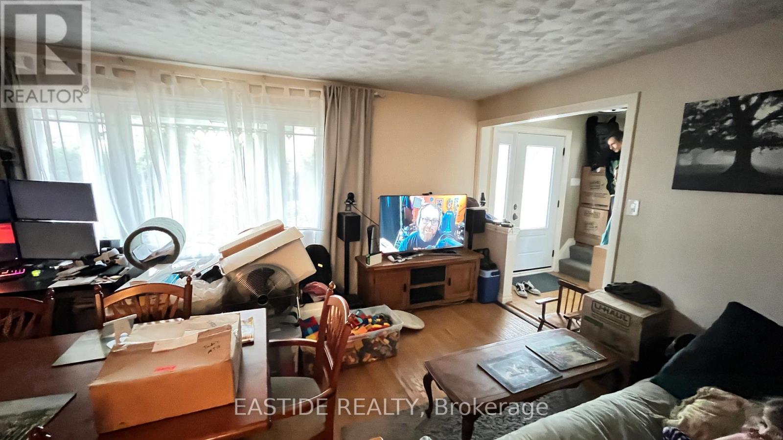 A living room with a television, a couch, and a coffee table.