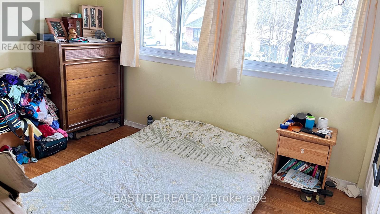 A bedroom with a bed, a dresser, and a nightstand.