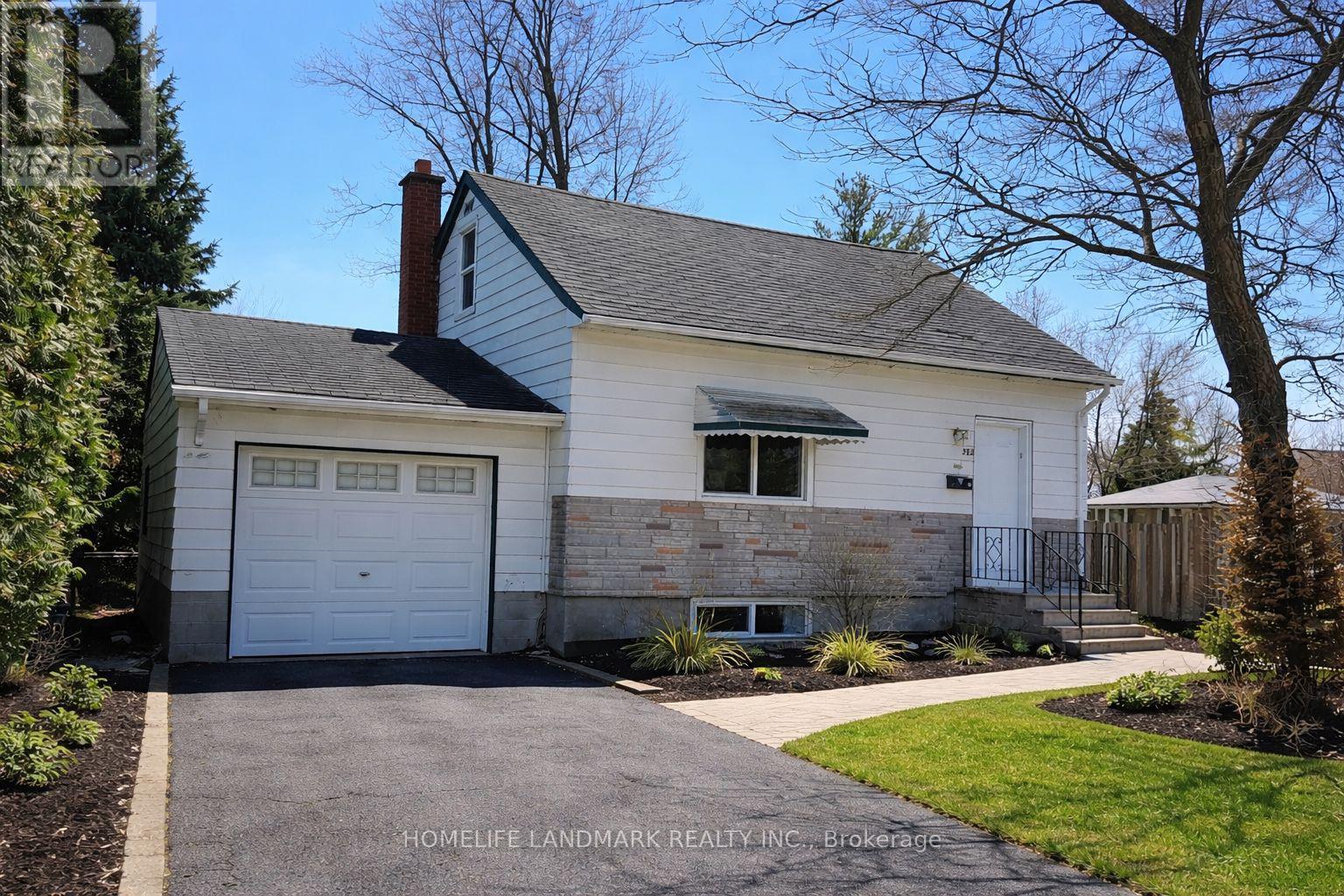A two-story house with a garage is for sale.