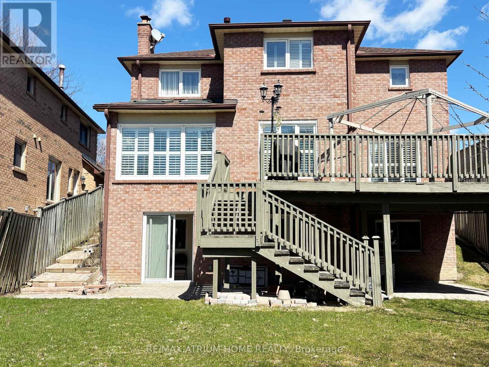 A house with a balcony and stairs leading to the entrance.