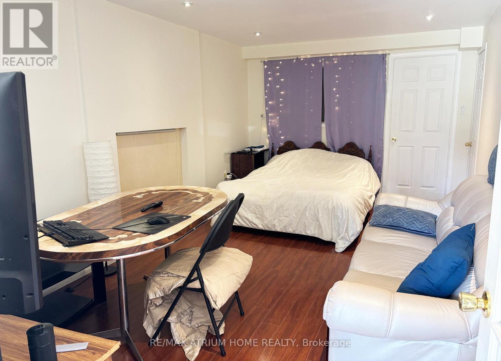 A bedroom with a bed, desk, and chair.