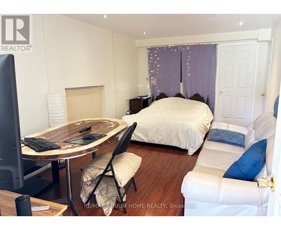 A bedroom with a bed, desk, and chair.