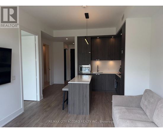 A modern kitchen with dark brown cabinets and a white island.