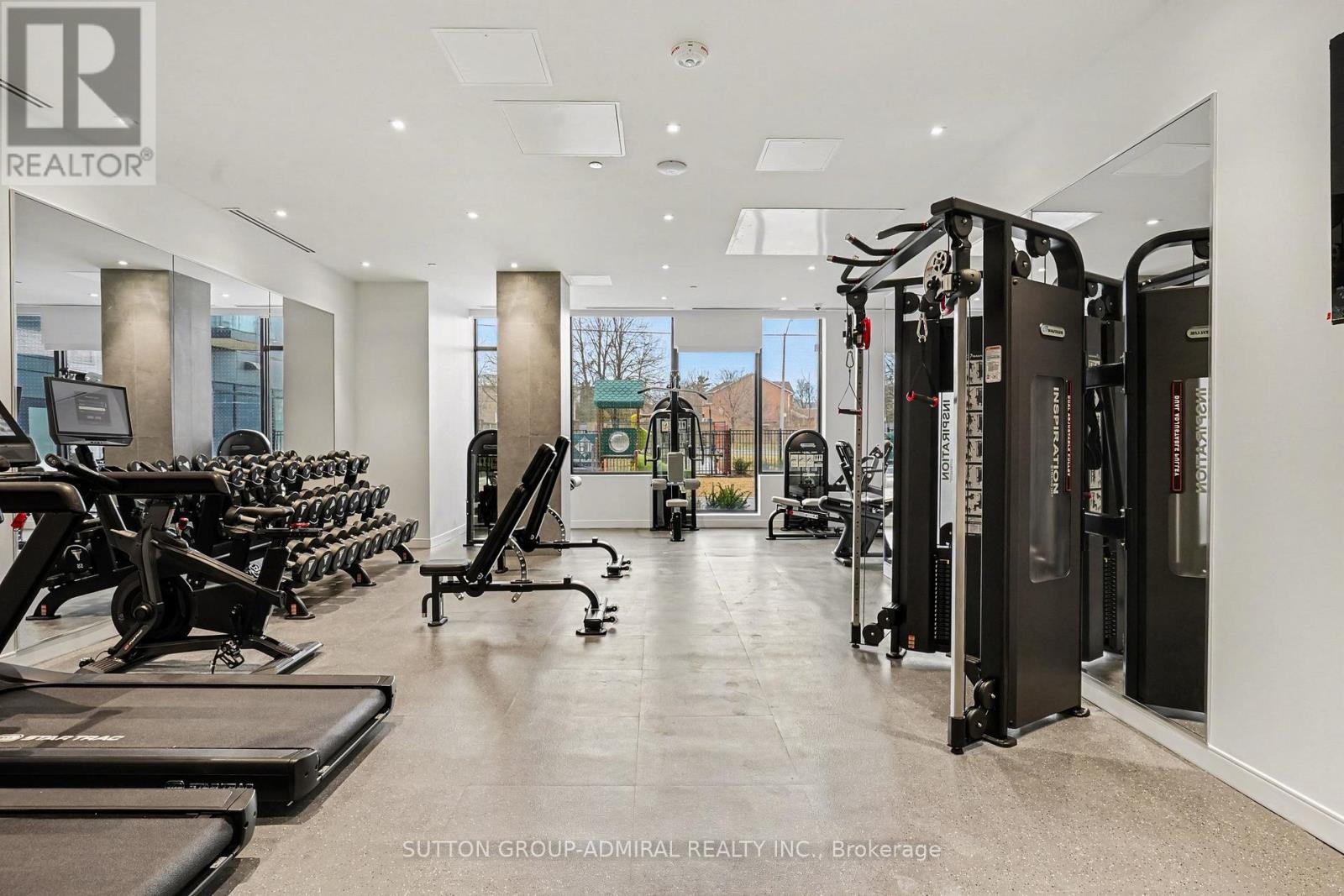 A gym with treadmills, weights and exercise machines.