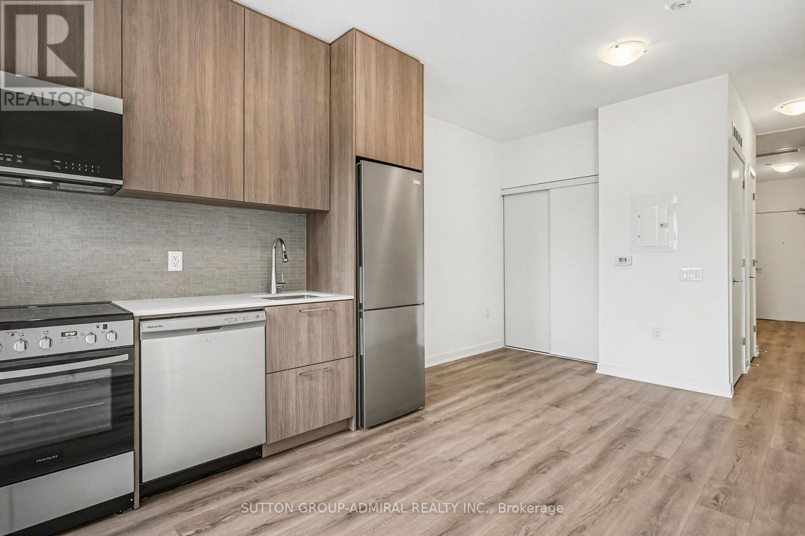 A kitchen with wooden cabinets and stainless steel appliances.