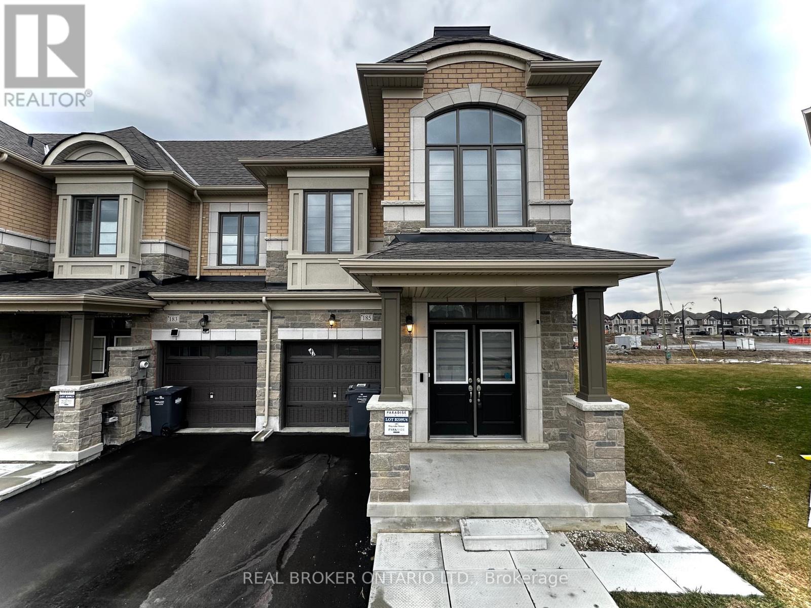A large, two-story house with a garage is for sale.