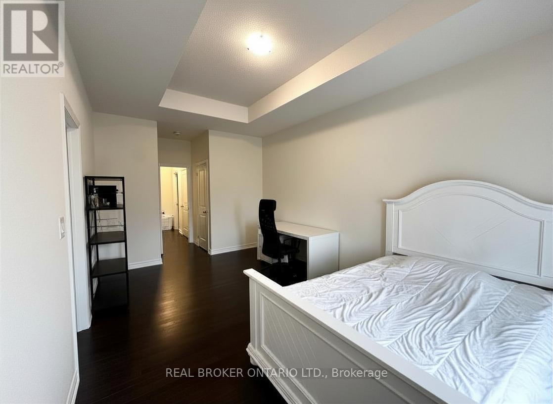 A bedroom with a large bed and a dresser.