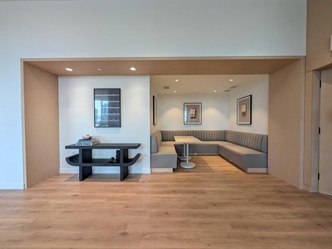 A modern living room with a black coffee table and grey sofa.