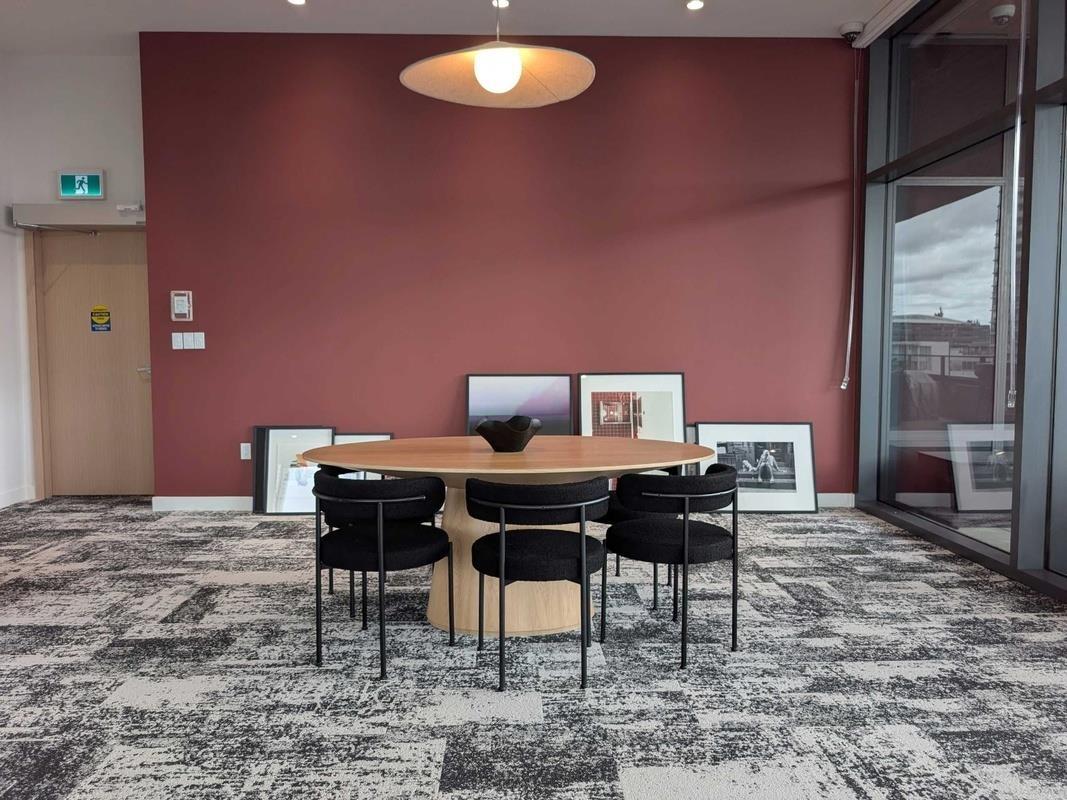 A conference room with a table and chairs.