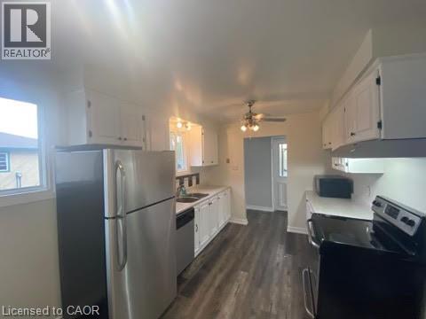 A kitchen with a refrigerator, stove, and oven.