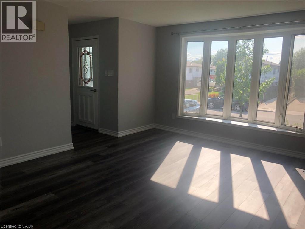 A room with a door and a window with sunlight coming through.