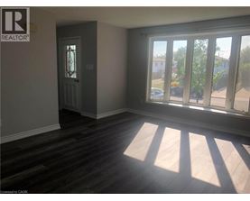A room with a door and a window with sunlight coming through.