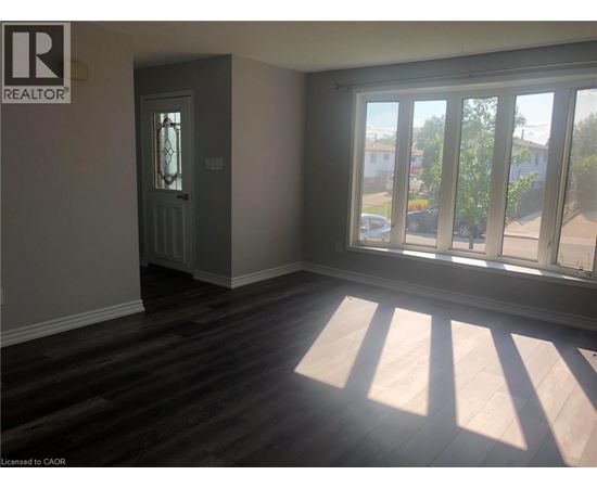 A room with a door and a window with sunlight coming through.
