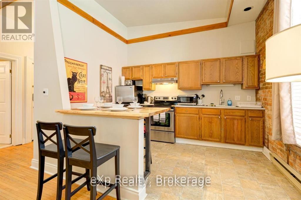 A kitchen with wooden cabinets and a tiled floor.