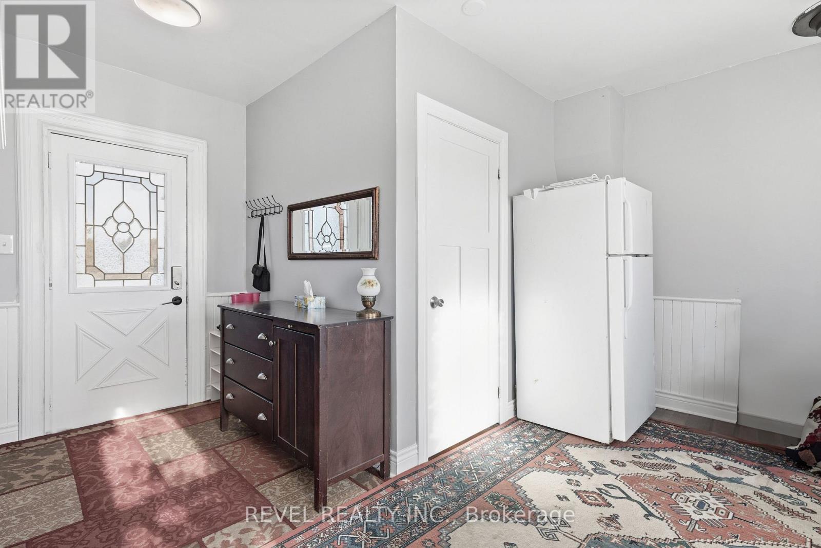 A bedroom with a dresser and a mirror.