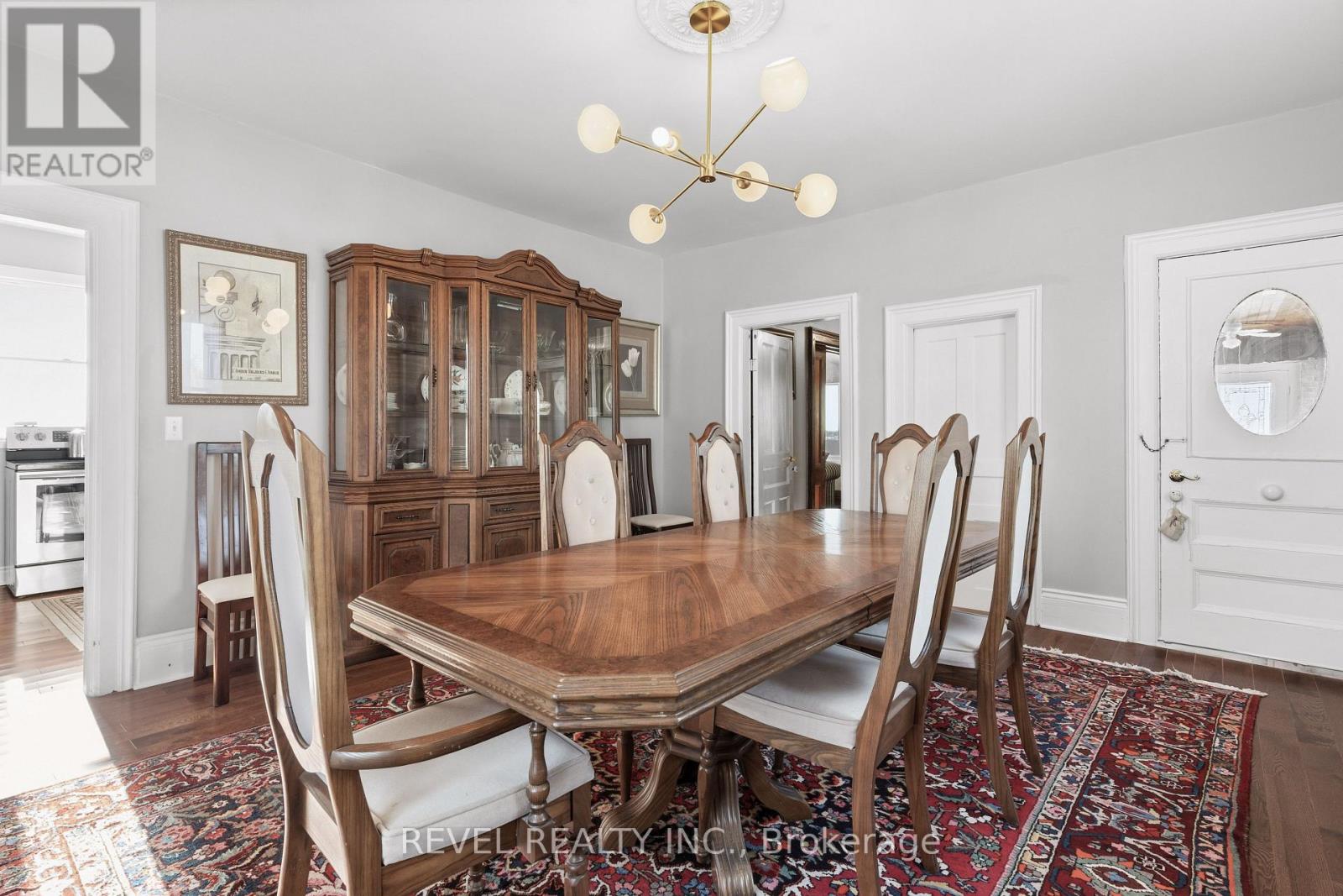 A dining room with a wooden table and chairs.