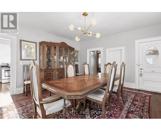 A dining room with a wooden table and chairs.