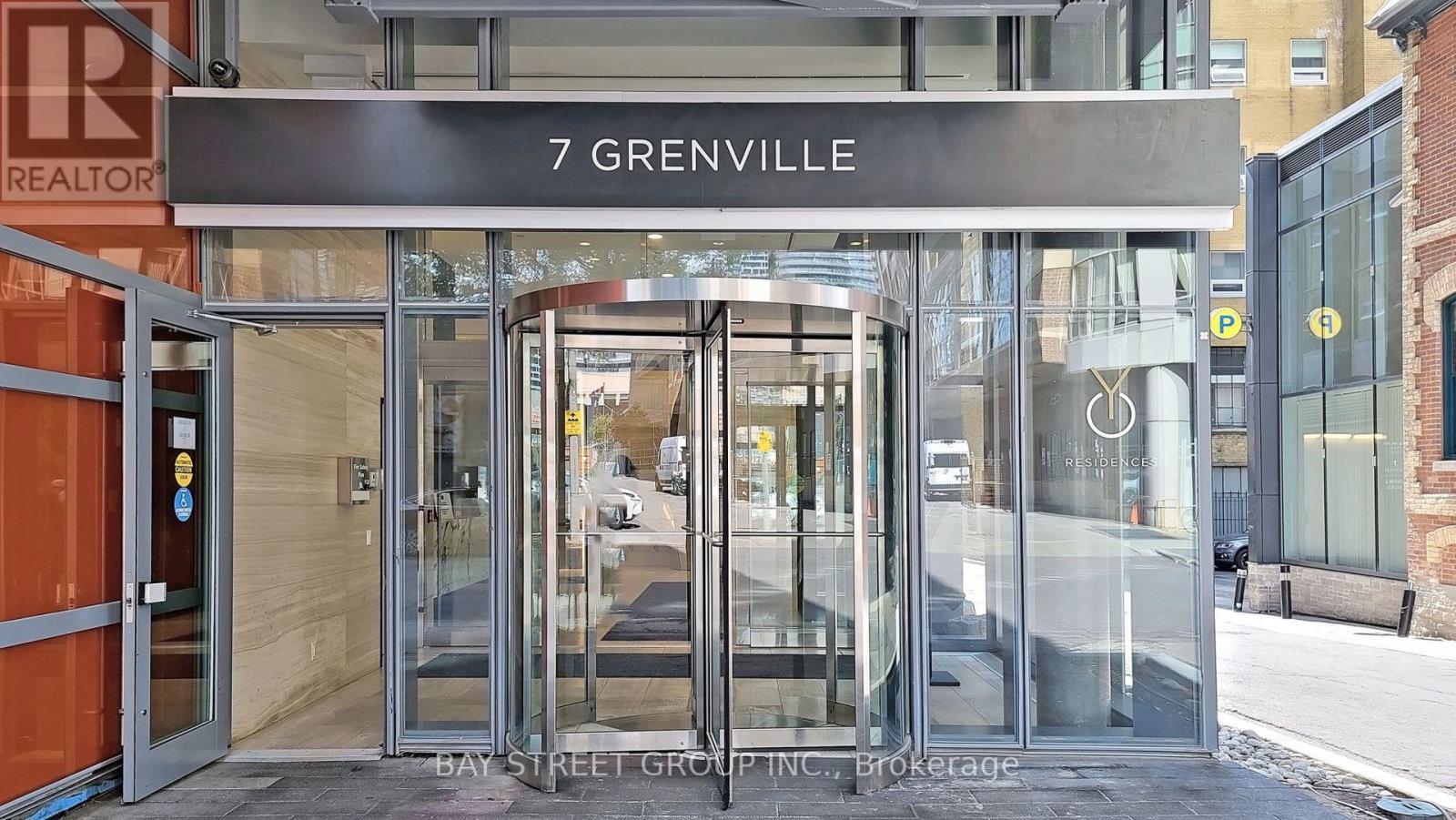 The entrance to a building with a glass door and a sign that reads "7 Grenville".