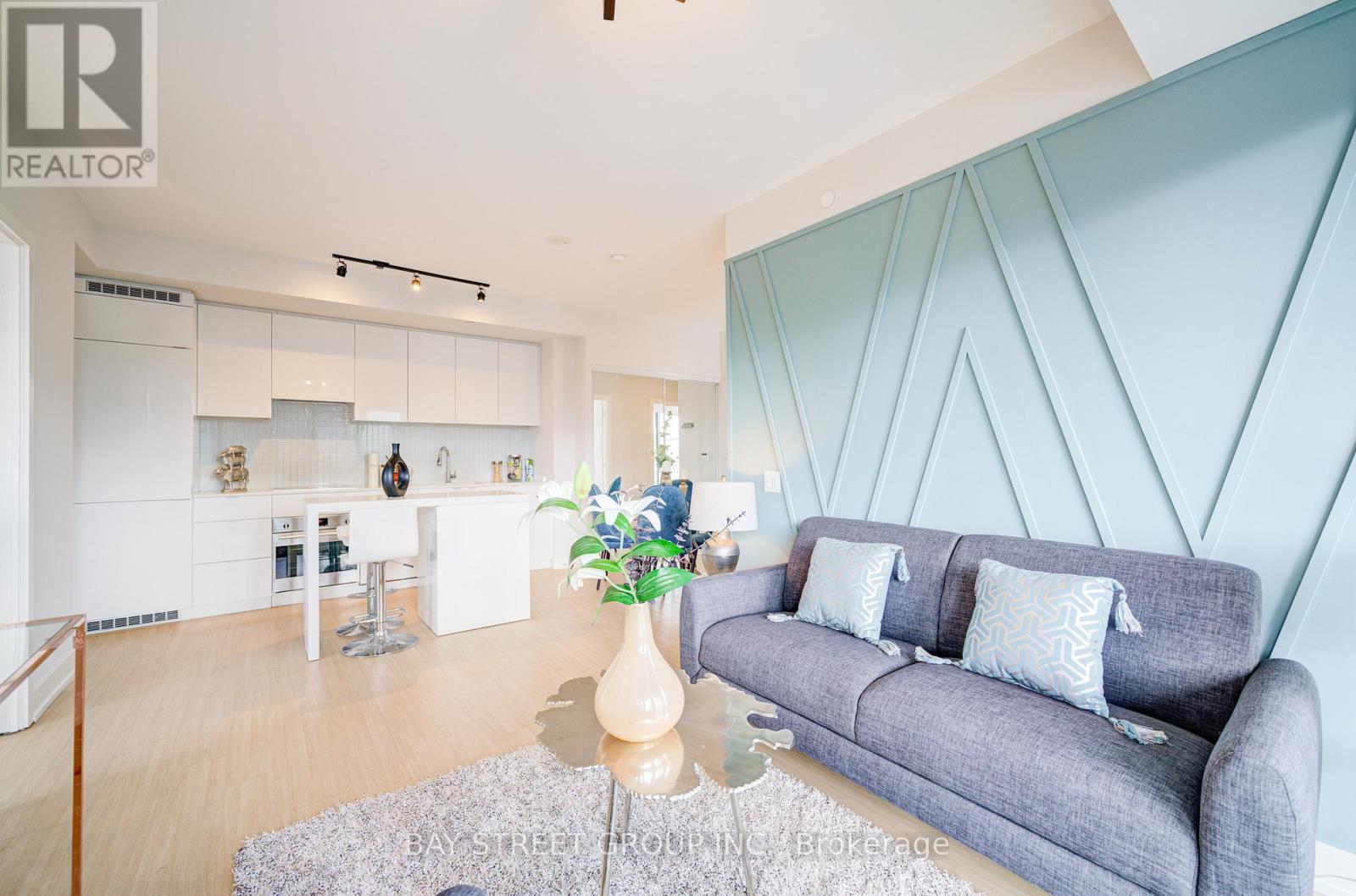 A living room with a grey couch and a coffee table.