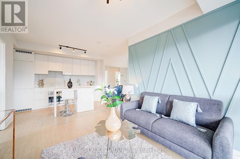 A living room with a grey couch and a coffee table.