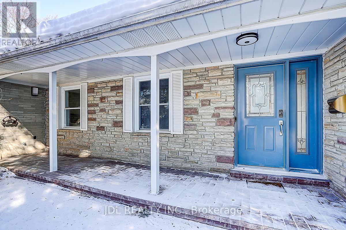 A house with a blue door and a stone wall.