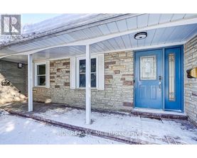A house with a blue door and a stone wall.