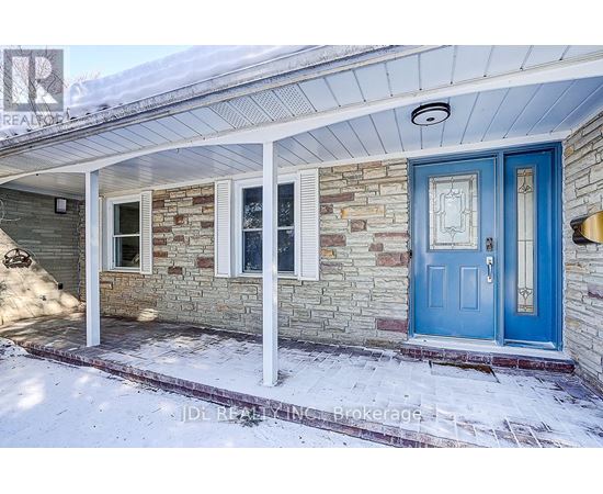 A house with a blue door and a stone wall.