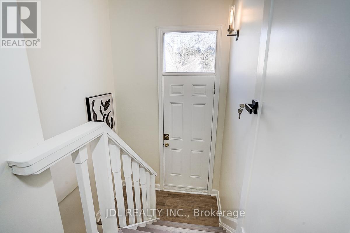 A white door is in a white room.