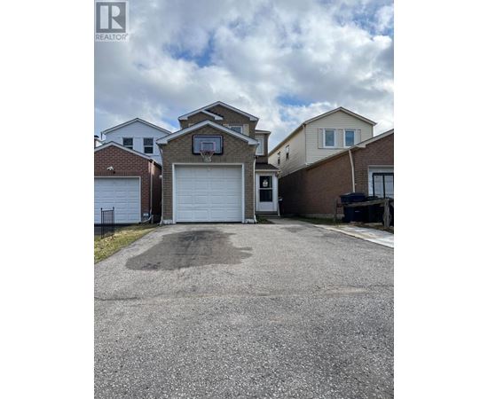 A real estate photo of a house with a garage.