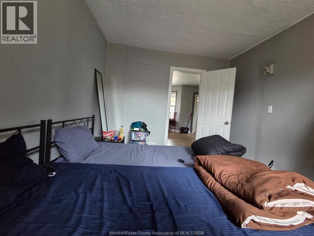 A bedroom with a bed, pillows, and a blanket.