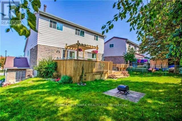 A house with a well-kept lawn and a wooden fence.