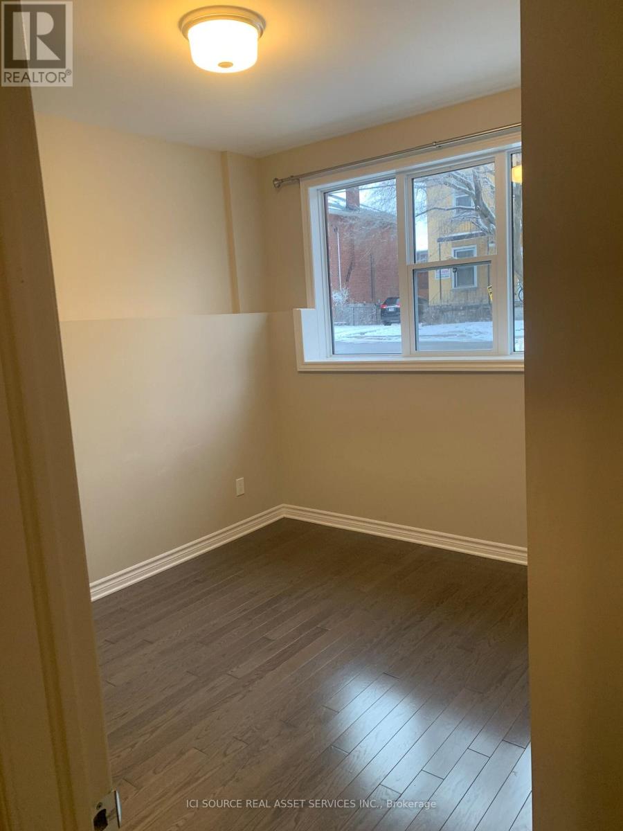 A room with a window and a view of a building outside.