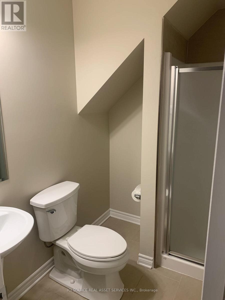 A white toilet sits next to a sink in a bathroom.