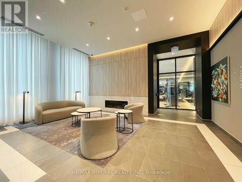 A modern living room with a fireplace and a large painting on the wall.