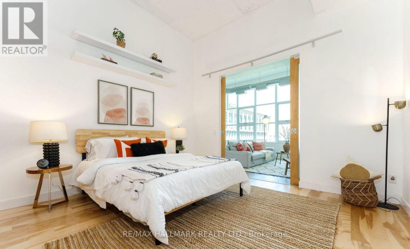 A bedroom with a large bed and a view of the balcony.