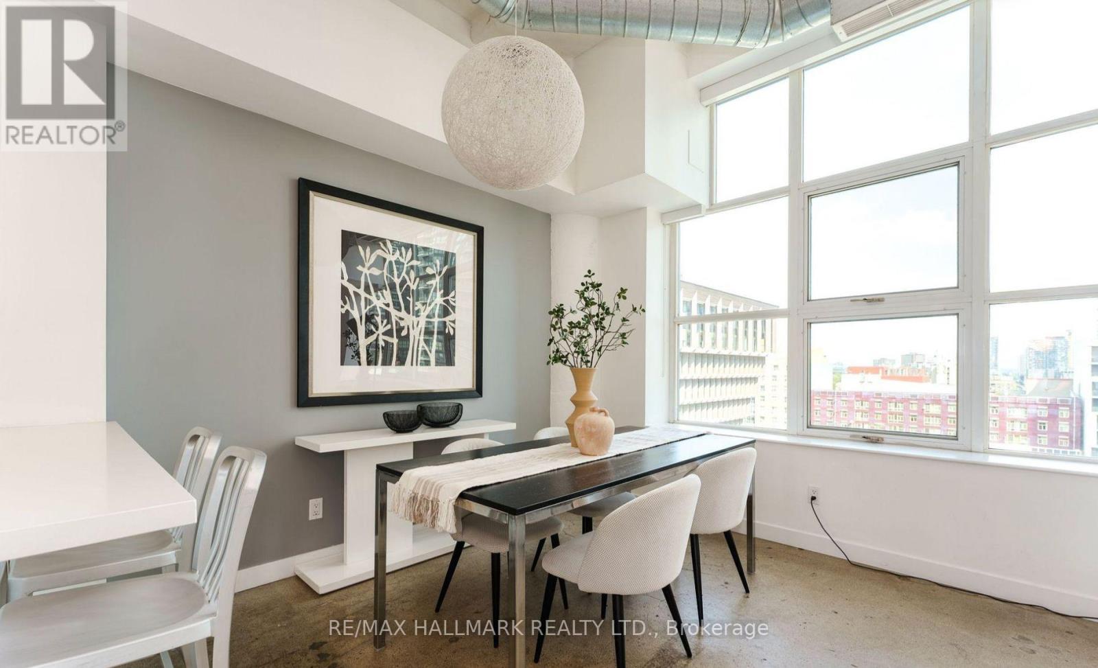 A dining room with a table and chairs.